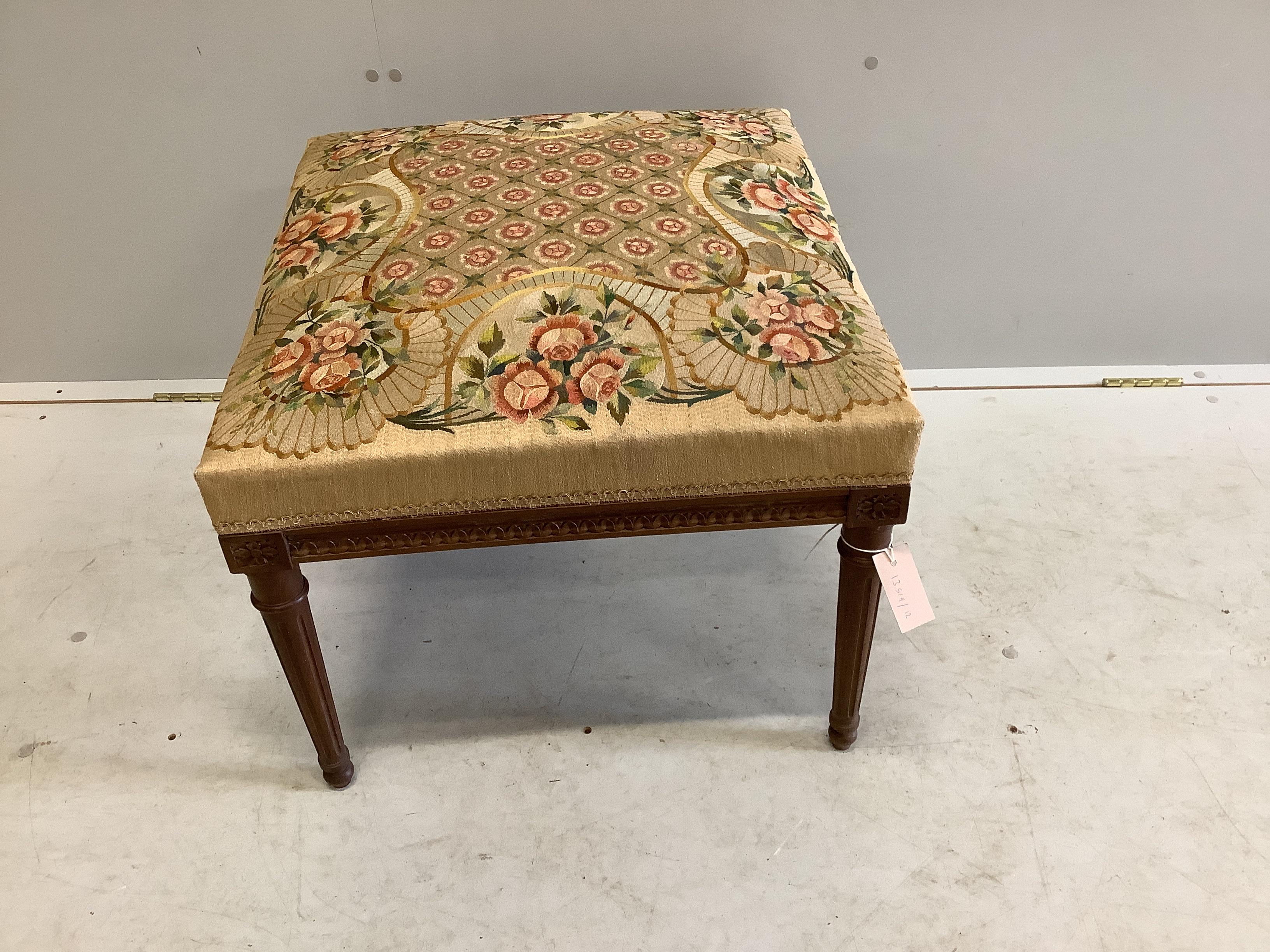 An early 20th century French beech stool with tapestry embroidered seat, width 56cm, height 44cm